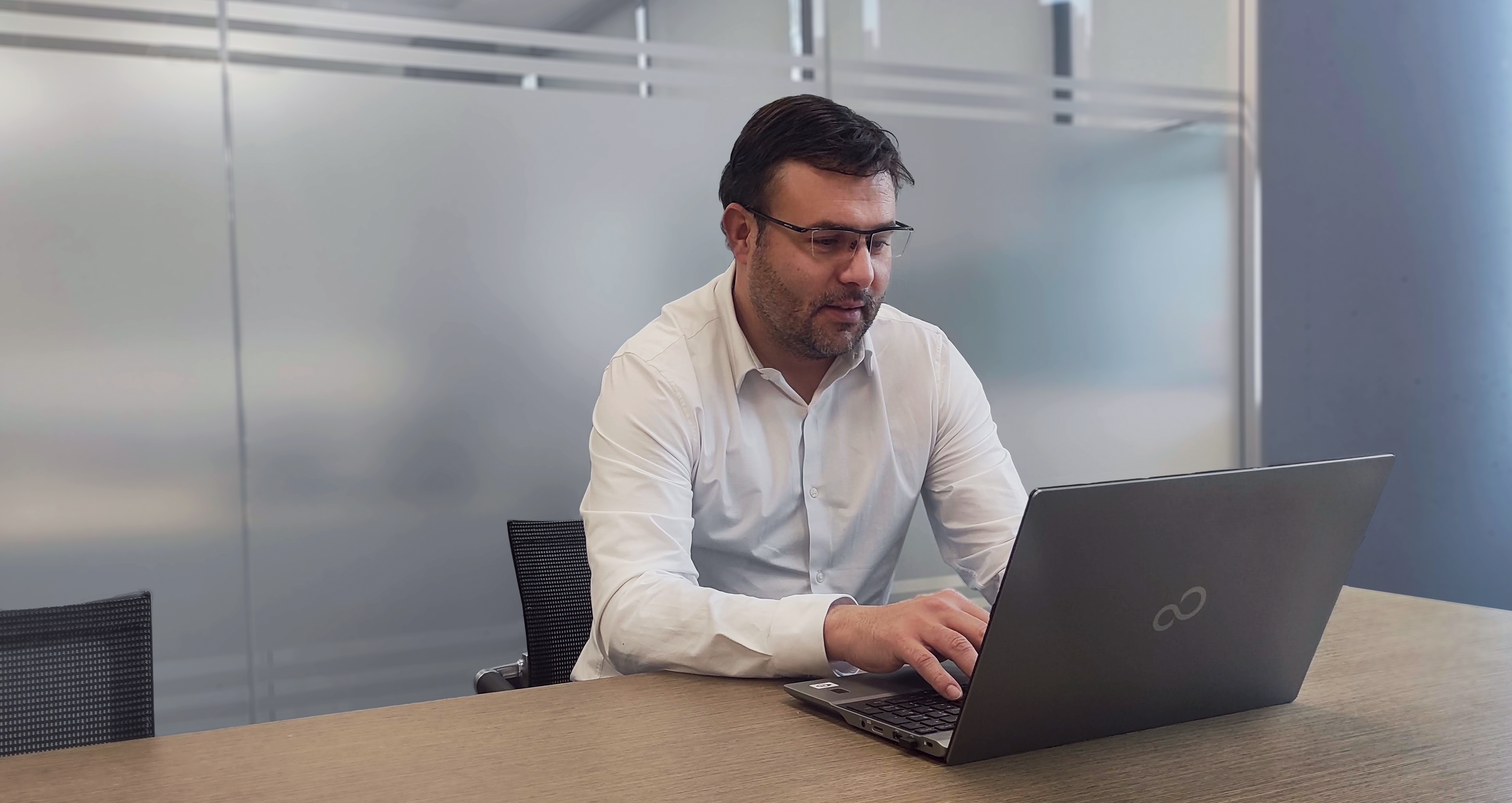 Man working on Laptop Smiling